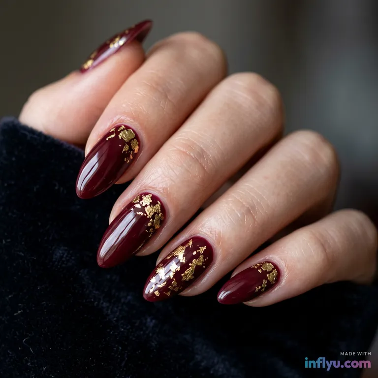 Burgundy almond nails with gold leaf accents, AI image
